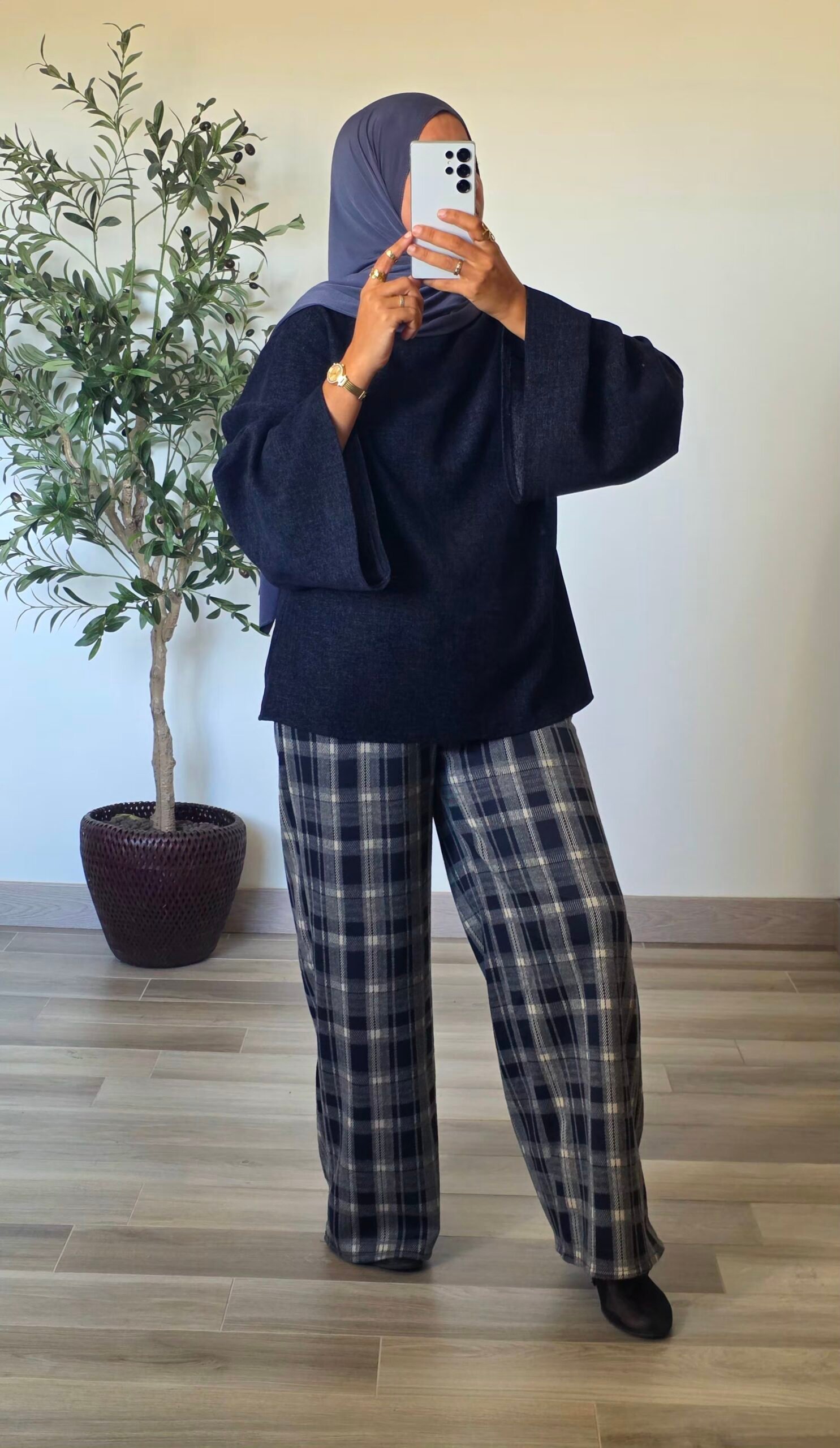 Femme portant une blouse en velours bleu marine, coupe ample et manches longues