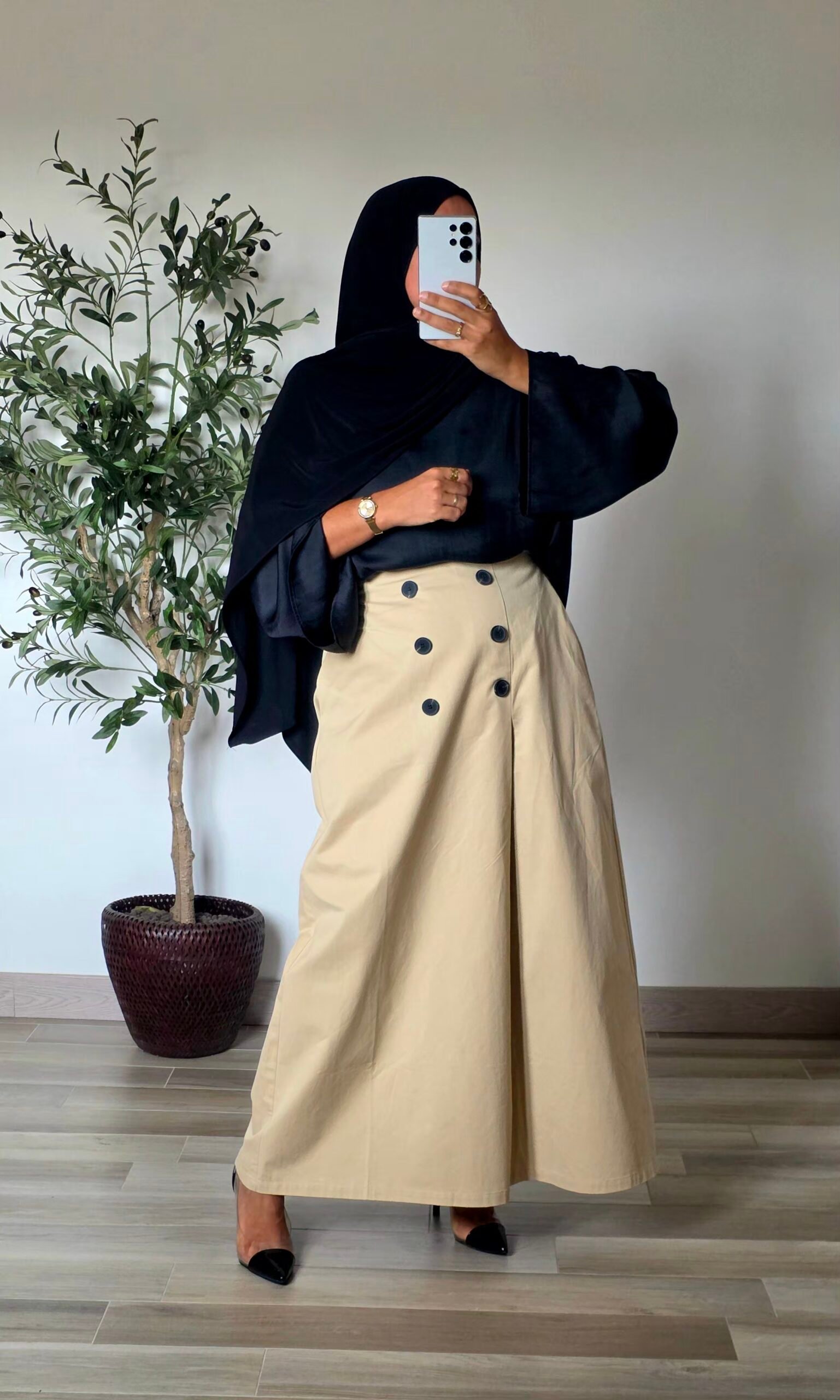 Femme portant une jupe longue trapèze beige en coton avec boutons sur le devant